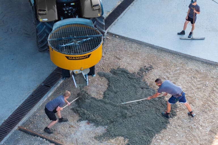 MAMMUT Zwangsmischer für Traktor TURBO MIX, Beton wird auf der Fläche von Arbeitern verteilt